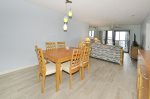 Dining / Living with ceramic wood grain tile flooring throughout.
